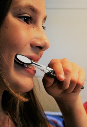 Texas young girl brushing her teeth